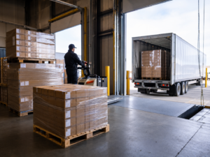 Prepared pallets and cartons staged at a warehouse loading dock for outbound pickup