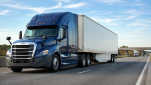 Modern semi truck with enclosed trailer for long haul truckload freight services.